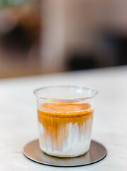 Coffee dirty menu - A glass of espresso shot mixed with cold fresh milk in coffee shop cafe and restaurant.vertical coffee dirty picture in cafe.specialty coffee.food beverage menu.japan drink idea.