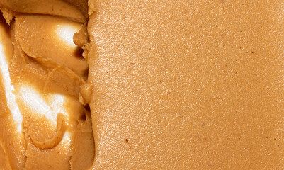 Brown peanut paste made from whole nuts.The texture of peanut paste top view.Peanut butter background. - obrazy, fototapety, plakaty