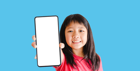 Obraz premium Happy kid tween teen asian girl holding phone smartphone mock up showing white blank display for advertising, text, promotion.Asian kid girl online learning app.banner background.Digital phone app.