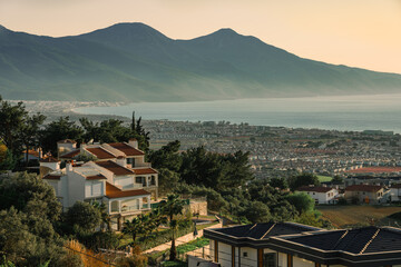 Fototapeta na wymiar Kusadasi Long Beach panorama with luxury villas and National Park hills in the background