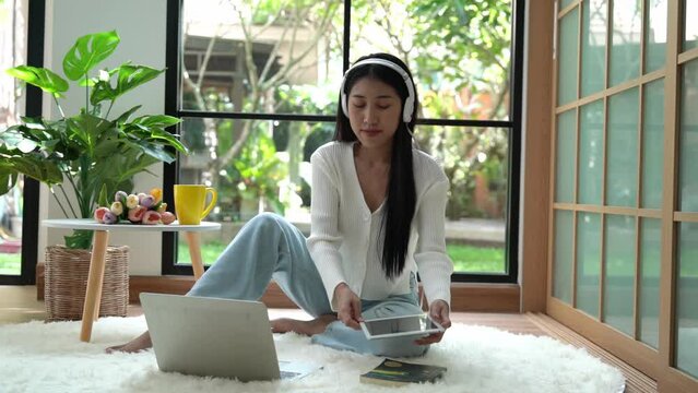 Young smiling woman working and meeting in living room.  Lifestyle girl using laptop for entertainment and relax chill after conference call.  Lifestyle Concept 