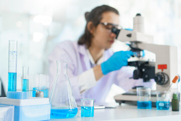 Laboratory research concept, Scientist using microscope to research and development of vaccine