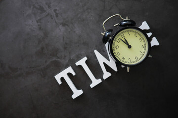Big alarm clock. The clock is on the table. The inscription "time". Time for rest and travel.