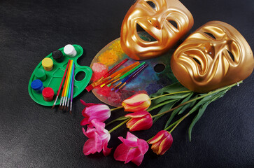 Attributes of the arts. Painting, theater. Art palette, brushes, theatrical masks and a bouquet of...