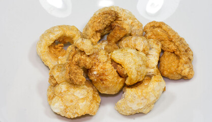 Pork skins or lean pork skins are fried to a puffy and crispy texture
