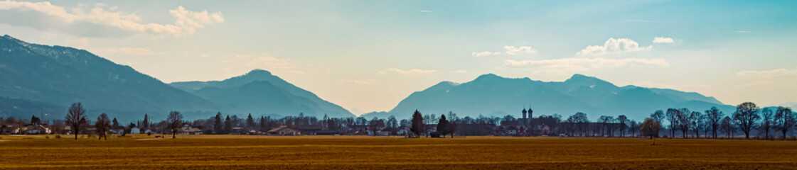 Fototapeta premium Beautiful winter view with a monastery and the alps in the background near Benediktbeuren, Bavaria, Germany