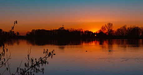 Beautiful sunset with reflections near Plattling, Isar, Bavaria, Germany