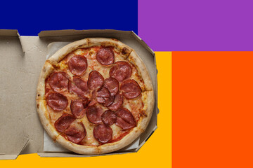 pepperoni pizza in a box on a colorful background