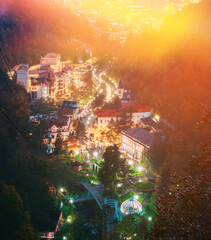 Borjomi, Samtskhe-Javakheti, Georgia. Aerial View Borjomi Cityscape And Central Park In Autumn October Evening Night In Night Illuminations Lights Lighting.