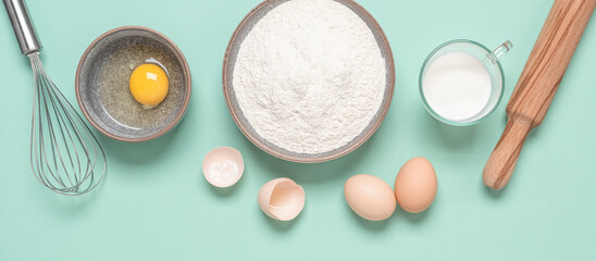 Baking ingredients on mint green pastel background. Baking background. Top view, flat lay. Banner