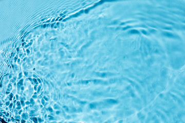  Liquid colored clear water surface texture with splashes bubbles.  Blue water waves in sunlight...