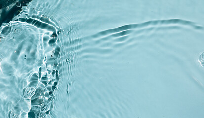  Liquid colored clear water surface texture with splashes bubbles.  Blue water waves in sunlight background.