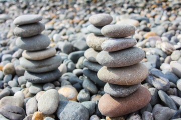 Pebble stones stacked on top of each other on a pebble beach