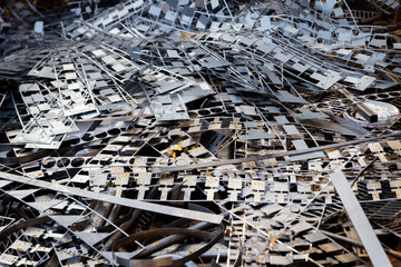 Waste metal from stamping press. Steel scrap from production prepared for recycling. 