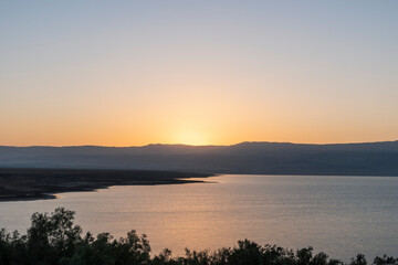 Obraz na płótnie Canvas Orange sunrise reflecting off of the Dead Sea. High quality photo