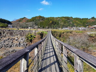 Fototapeta na wymiar Wooden Suspension Bridge above the Ogata River at Harajiri Falls