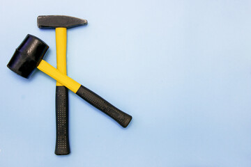 hammer, mallet on a light blue background with copy space