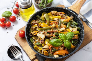 Vegetarian wok stir fry. Seafood shrimps, calamari, cuttlefish stewed with vegetables and garlic sauce on a marble tabletop.