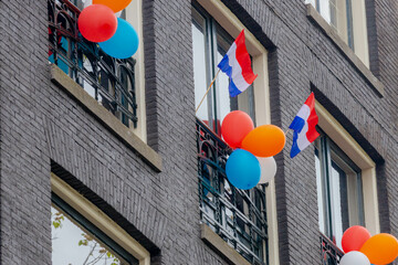 Color of King's Day, Outdoor decoration with balloons and with Netherlands flag (red, white, blue) Celebration of the birthday of the King, National holiday Koningsdag in Dutch, Amsterdam, Netherlands