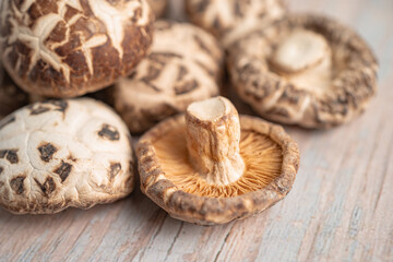 Dried shiitake mushroom on wooden background. Healthy food.