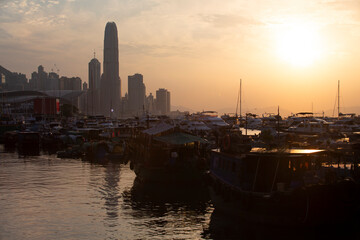  junk boats with the backlit of skyscrapers  in Hong Kong island, the view of typhoon shelter