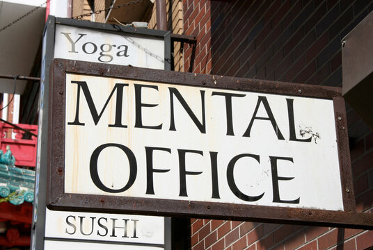 Office building signs for yoga, mental health and sushi businesses.