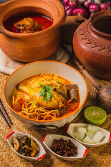 Khao Soi Kai,Delicious northern Thai food,Arranged with seasonings on the table.