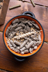 sunflower cake flakes with grass and bran granules and cereals for horses and other domestic animals in bowl. food concept. flat lay