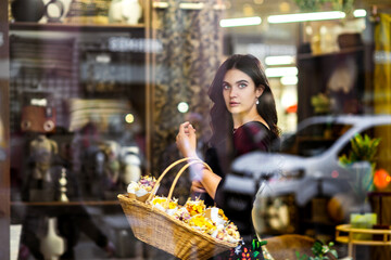 Beautiful Ukrainian girl with a basket of flowers.