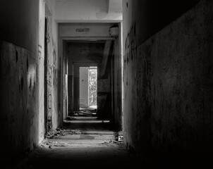 Ghost of man in abandoned building. Silhouette in abandoned building. Ghost in corridor. Black and white photo. 