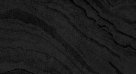 close up luxury marble interior carpet in dark black color tone use as background. modern design carpet of machine work. art decorative concept for house, condominium or office.