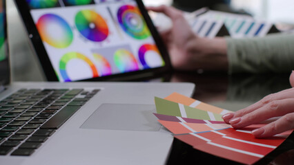 Close up of designer study color palette on digital tablet sitting at desk