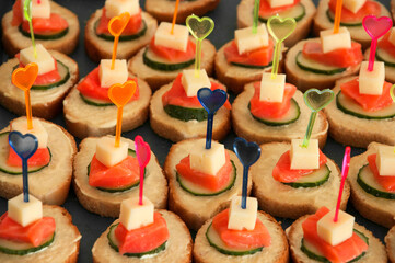 sandwiches with red fish. delicious food on a plate. quick snack on the table	