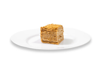 A piece of cake, layered on a white plate on a clean white background.