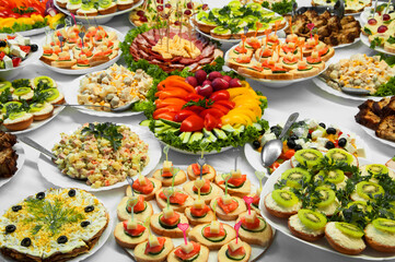 delicious dishes on the festive table. different food on the wedding table. the concept of celebrating an important event. buffet table with sandwiches and cold cuts