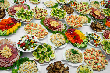 delicious dishes on the festive table. different food on the wedding table. the concept of celebrating an important event. buffet table with sandwiches and cold cuts