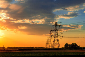 An electric high voltage tower at sunset