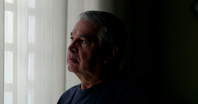 Contemplative 60 Year Old Man Looking Outside During Quarantine