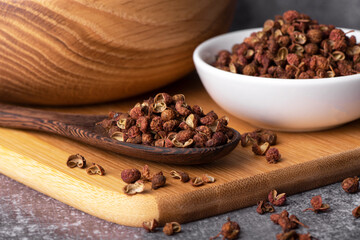 Chinese pepper, Sichuan pepper in wooden spoon. Dry Sichuan Pepper Spice.
