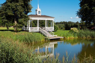 Village of Stepanovskoe-Volosovo. Russia, Tver region. Small pond with a beautiful and cozy gazebo...