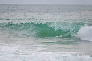 Fototapeta premium A powerful crystal green ocean wave on a beautiful beach, Phuket, Thailand.