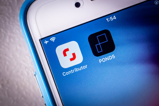 Kumamoto, JAPAN - May 11 2022 : Conceptual image of Shutterstock and POND5 icons on an iPhone home screen in a dark mood. Shutterstock announced that acquisition of Pond5 in May 2022