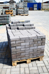 concrete paving slabs stacked on pallets outdoor of workshop