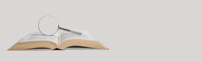 Banner with open book and magnifier. Education and science concept. Careful reading, paying...