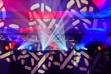 Fototapeta na wymiar colored soffits and spotlights illuminating the stage in nightclub