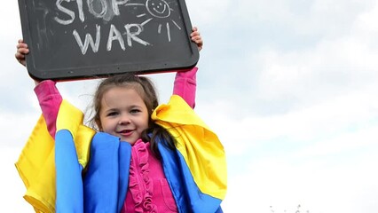 Children against war. War in Ukraine. The child holds the inscription stop war. Stop the war. Ukrainian children. Child with Ukrainian flag. Girl with the slogan stop war