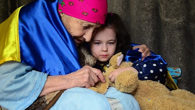 A woman with a child in a bomb shelter. War in Ukraine. Grandmother in the basement during the war. Peace concept. Russian aggression against Ukraine. Bombardment of Ukrainian cities. Childhood in war