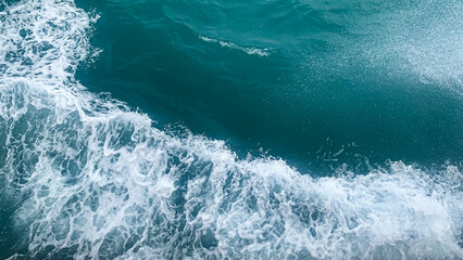 Aerial view to ocean waves. Blue water background. Side the boat - 503997519