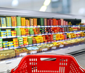 choosing a dairy products at supermarket.empty grocery cart in an empty supermarket