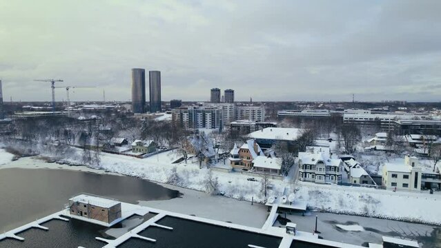 Aerial drone view over Riga's Vansu bridge and Daugava River, snow covered rooftops, Riga, Latvia, Europe